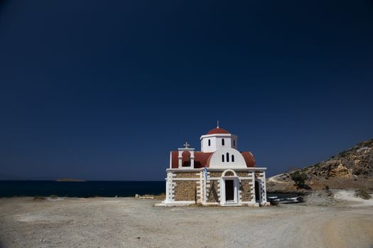 Greek church on the shore on sunny day.