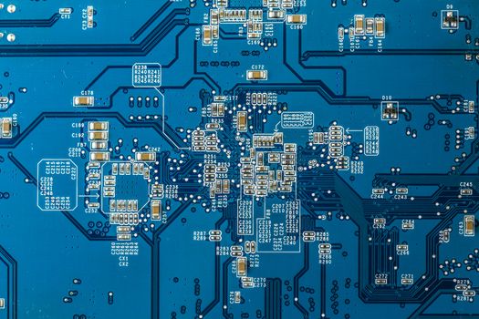 Close up photo of blue printecd circuit board with electronic parts