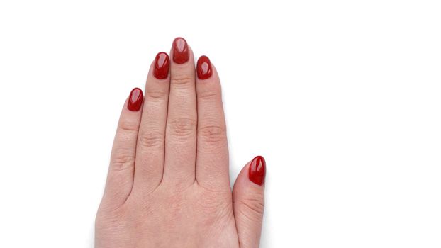 Beautiful female hand with fresh red manicure and nail isolated on white background