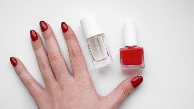 Beautiful female hands. Hand skin care. Beautiful Woman Hands With Red Manicure. Red nail polish and Cuticle oil.