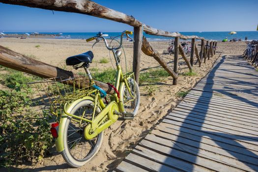 Nice retro vintage bicycle near beach on wooden road, sunny day