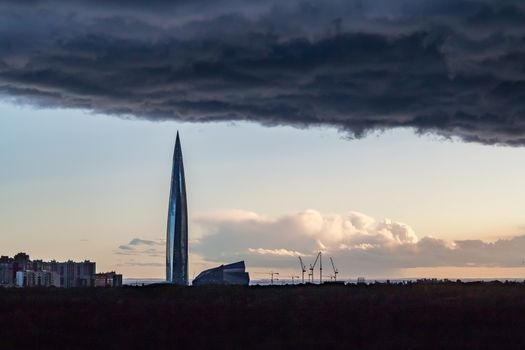 huge thundercloud on the outskirts of the city before the rain - image.