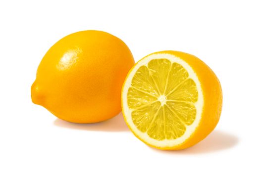 Fresh orange Tashkent lemons or Meyer lemons, one whole and one half isolated on white background with shadow.