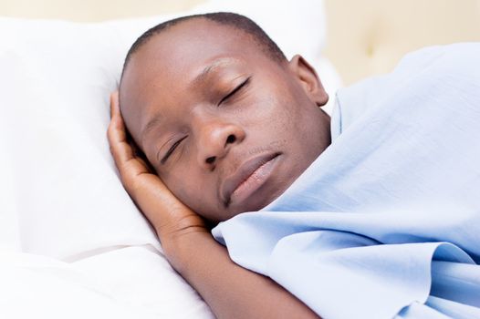 this young man asleep and enjoying the comfort of the bed