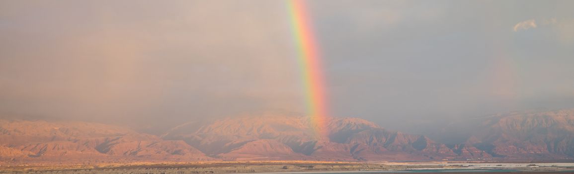 rainbow over the dead sea with jordan as background, view from masada