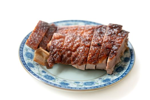 Roast duck meat slices on plate isolated white background. 