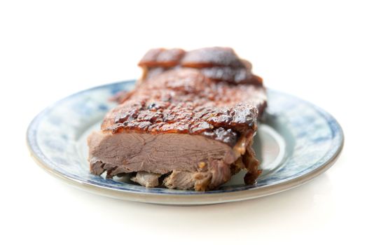 Roast duck meat slices on plate isolated white background. 