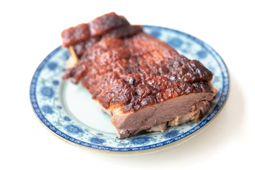 Roast duck meat slices on plate isolated white background. 