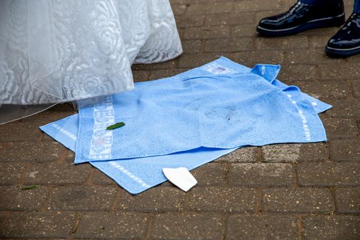Towels and torn plate in the wedding ceremony, Latvia. Wedding Tradition with broken plate. Newlyweds, towels and broken plate pieces.