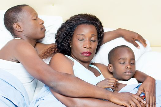 family lying in bed sleeping peacefully