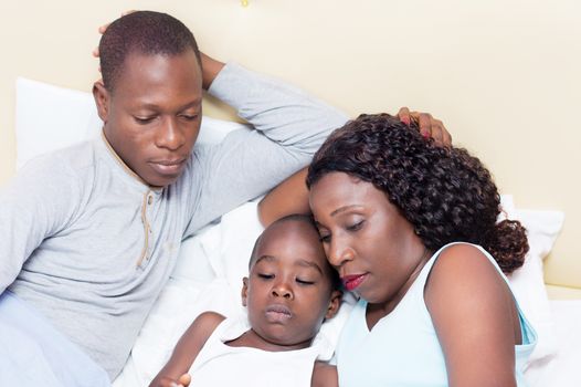 this young couple watching their child play with the mobile phone.