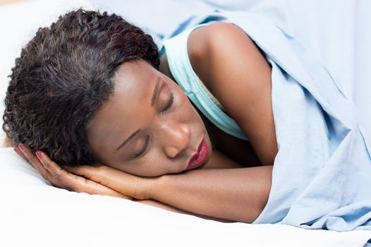 Pretty woman sleeping in her bed