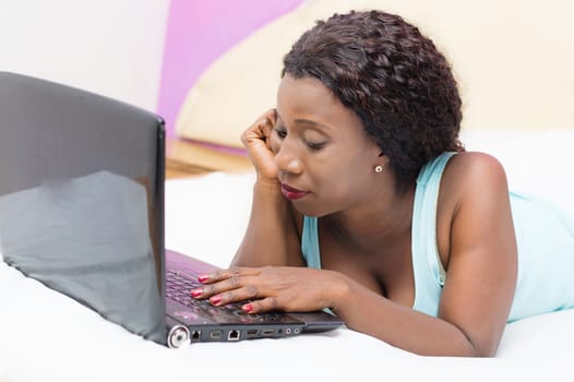 This young woman is very concentrated on her research in her room