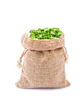 organic green split peas filling in sack bag isolated on a white background.