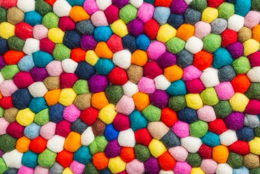 Multicolored felt ball rug detail, colorful texture