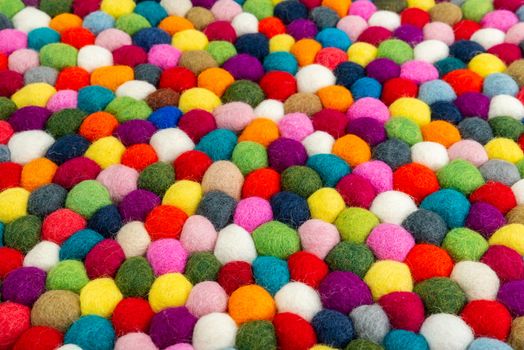 Multicolored felt ball rug detail, colorful texture