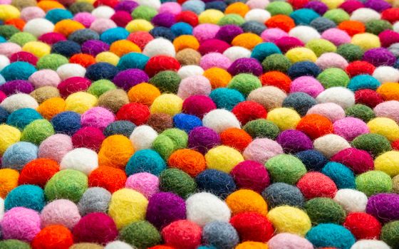 Multicolored felt ball rug detail, colorful texture