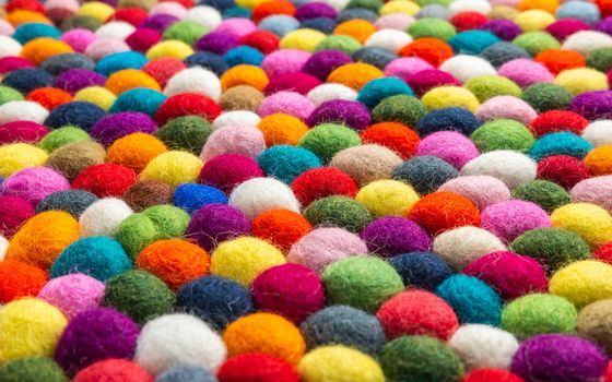 Multicolored felt ball rug detail, colorful texture