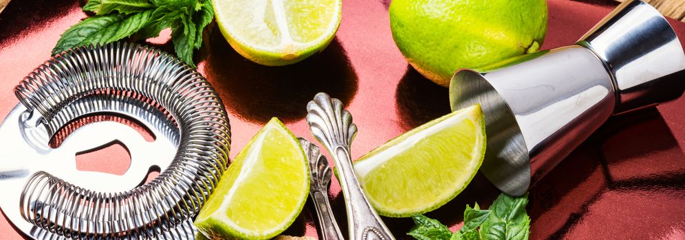 Fresh mojito cocktail and bar utensils.Mojito cocktail with mint and lime