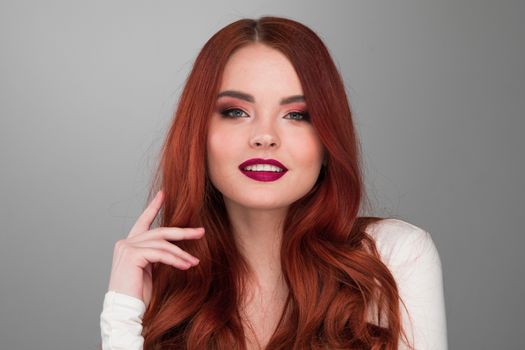 Portrait of young woman with long beautiful ginger hair