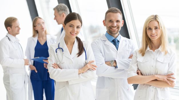 Successful team of medical doctors are looking at camera