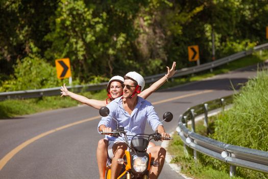 Happy couple on a scooter at summer vacation