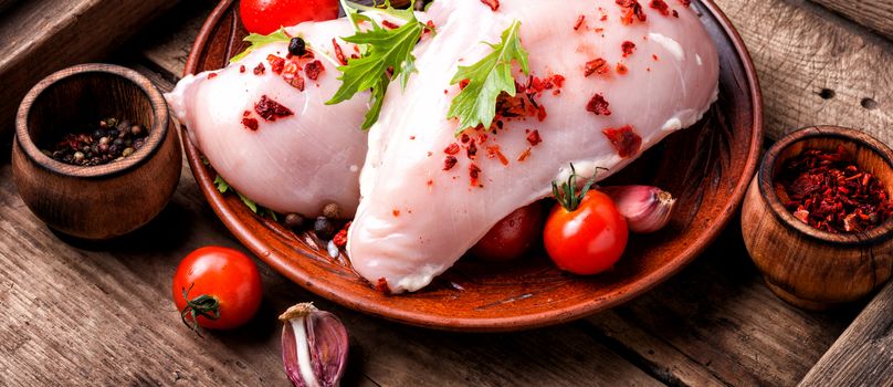 Raw chicken breast on wooden background.Long banner