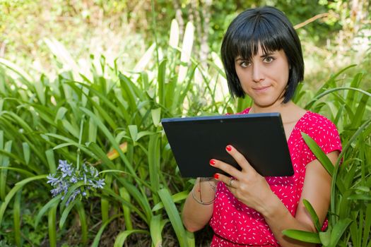 casual woman working with a tablet pc, outdoor