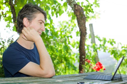 casual man working with a tablet pc, outdoor