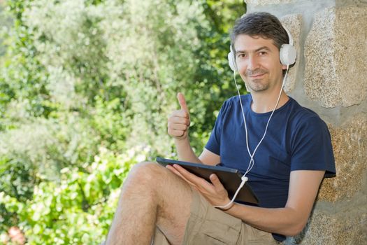 casual man working with a tablet pc, outdoor