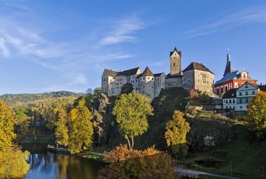 Loket Castle is a 12th-century Gothic style castle located about 12 km from Karlovy Vary on a massive rock in the town of Loket