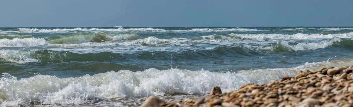 the ocean near tel aviv in israel with waves and rocks on the beach