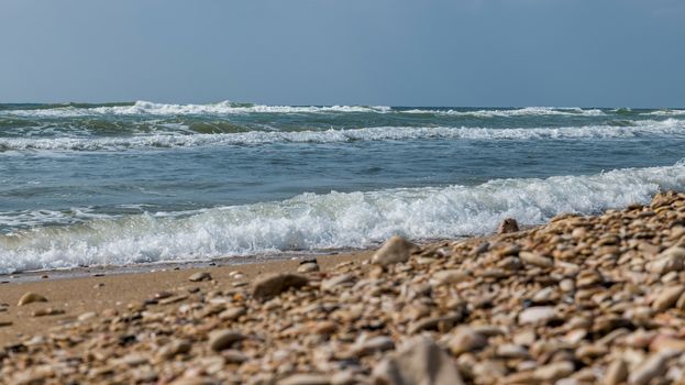 the ocean near tel aviv in israel with waves and rocks on the beach