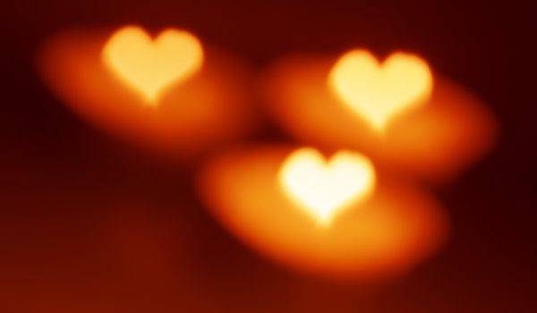 Heart shape, bokeh style, candles. Abstract love blurred background. Good mood.