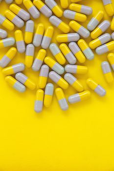 Capsule pills on yellow background