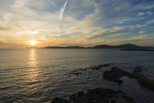 amazing colorful sunset in the Gulf of Alghero, Sardinia, Italy