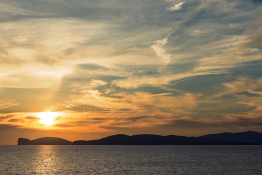 amazing orange sunset on the giant that sleeps in Alghero, Sardinia, Italy