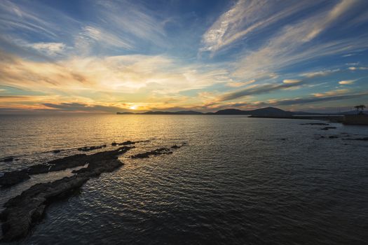 spectacular colorful sunset in the Gulf of Alghero, Sardinia, Italy
