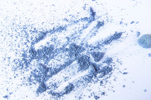 Blue or gray eye shadows, scattered crumbs on white background.