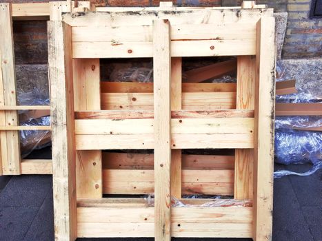 Dirty wooden pallets left on the wall. Construction and industrial transport