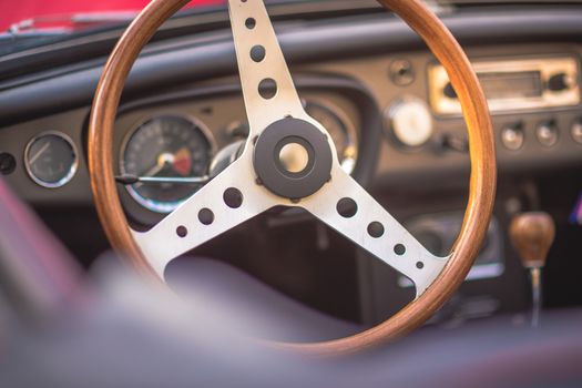 Classic vintage car interior, close up on steering wheel, dasboard,