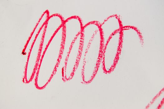 Red line, stroke, splash cosmetic pencil on white background.