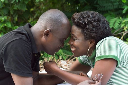 loving couple with forehead against forehead and lying prone.