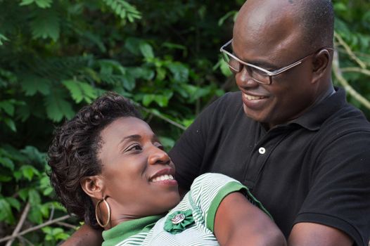 this young woman lying on her husband, looks at him with a beautiful smile