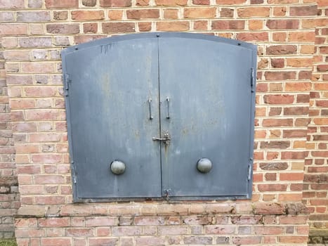 red brick wall or masonry and iron metal door