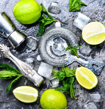 Mint, lime, ice ingredients and bar utensils