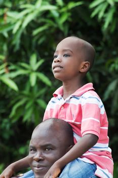 father carrying his son on his shoulders so he could enjoy the scenery.