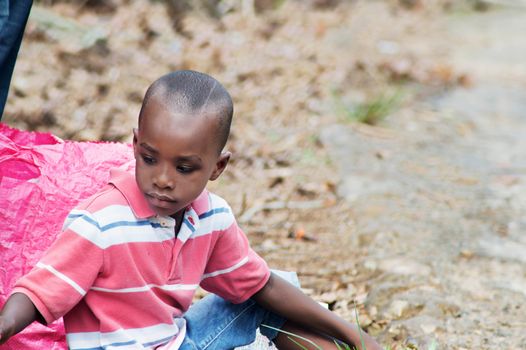 child sitting on the floor, looking back having fun