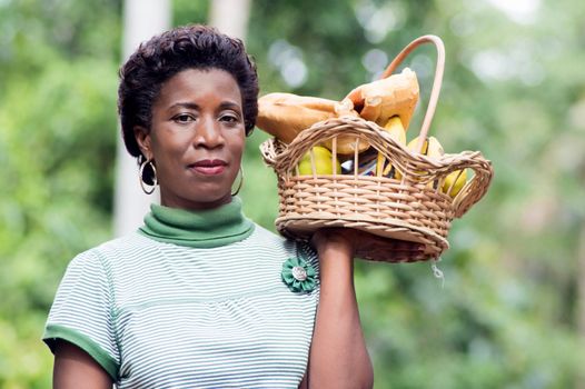young woman holding a basket of fruit in her hand and went for a picnic