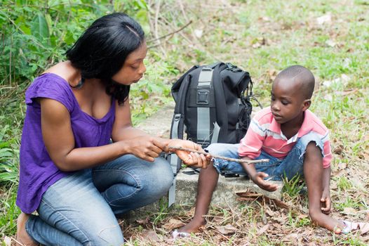 this young woman and the boy are sitting along the way to have some fun.
